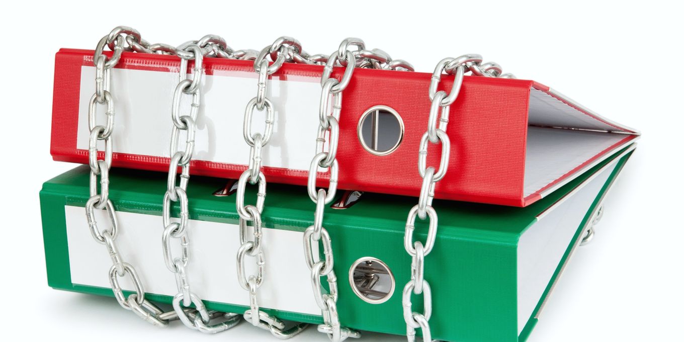 Two ring binders wrapped in a steel chain